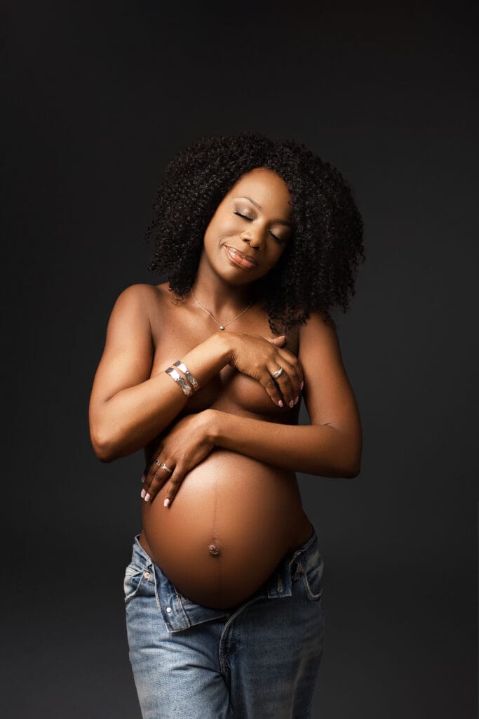 Séance photo grossesse en studio avec lumière artistique mettant en valeur le ventre rond d’une future maman – photographe grossesse 77